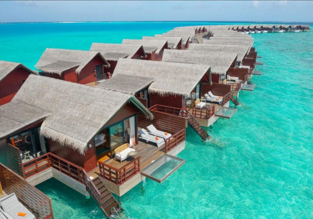Aerial view of Maldives atolls surrounded by vibrant coral reefs and calm blue waters