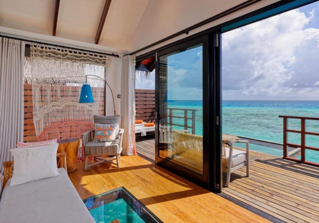 Couple enjoying a private infinity pool overlooking the ocean at a Maldives luxury villa