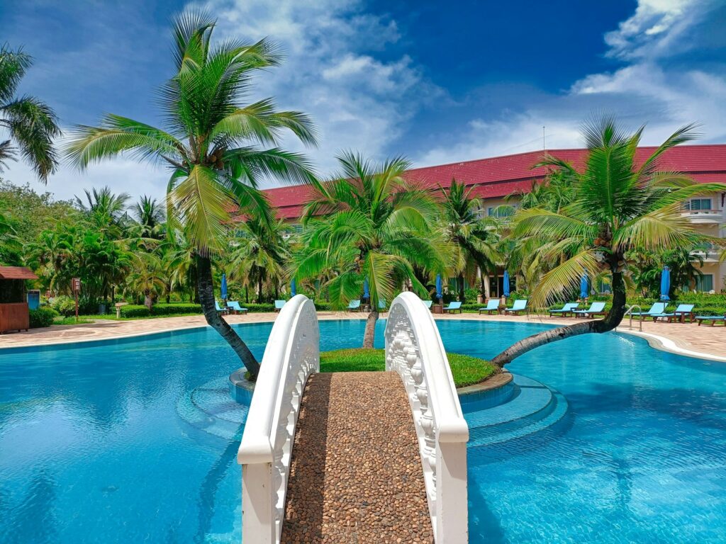 a swimming pool with palm trees in the background